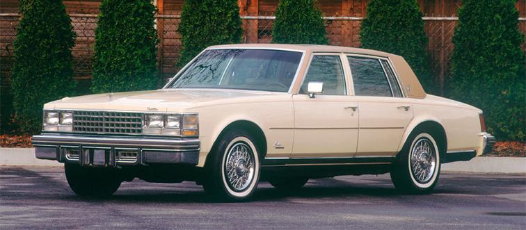 a tan car in a parking lot