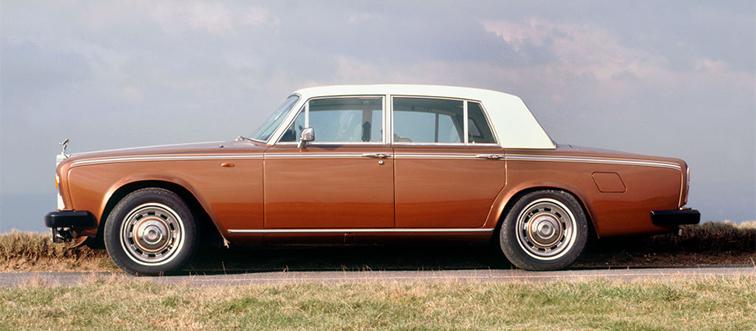 an orange and white car on the side of the road