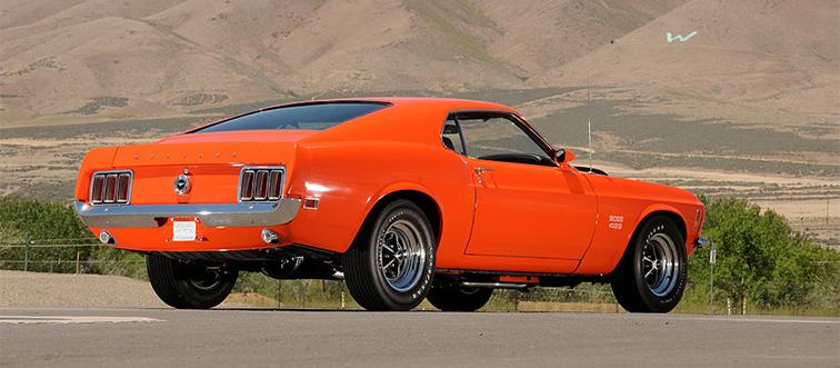 an orange car near mountains