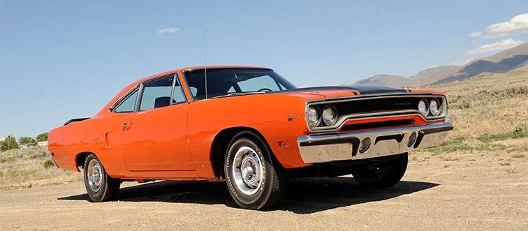 an orange car near mountains