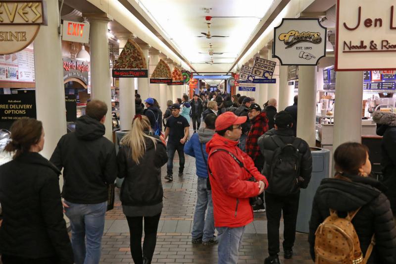 a crowd lining up for food at Faneuil Hall and Quincy Market