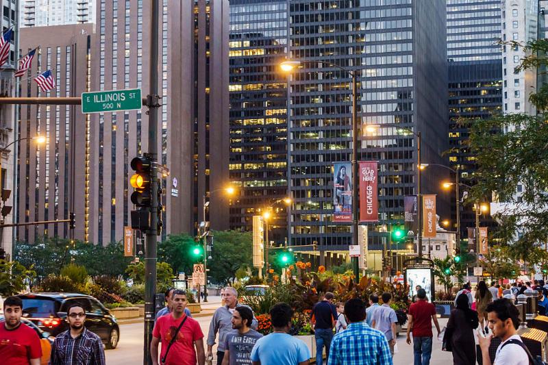 people walking along the magnificent mile during sun down