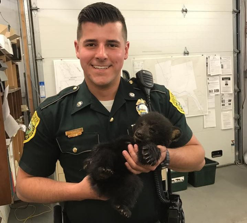 police-officer-holding-bear-cub
