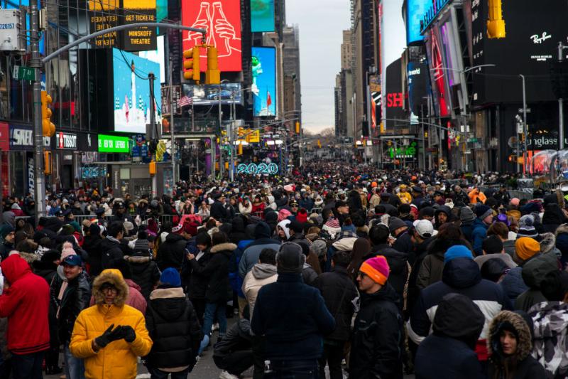 a crowd in the middle of times square