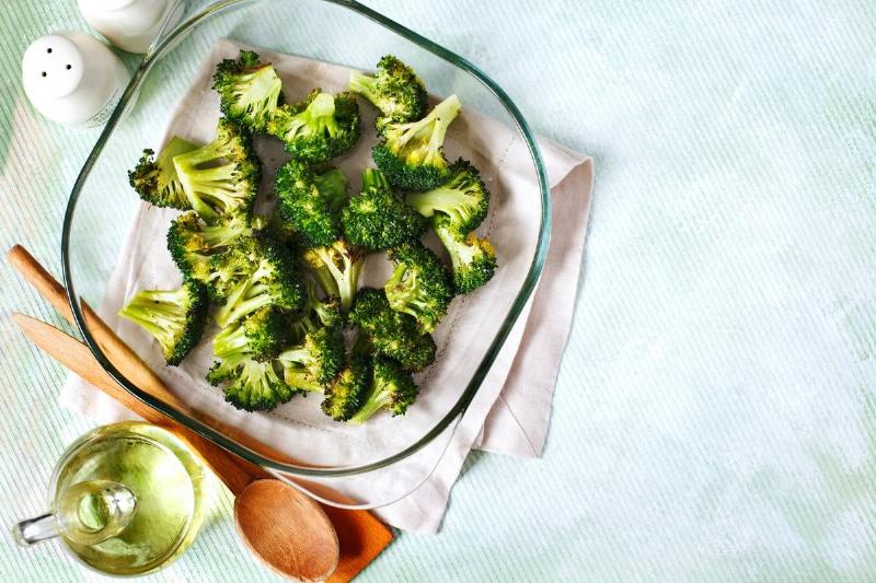 A top view shows baked broccoli in a pan.