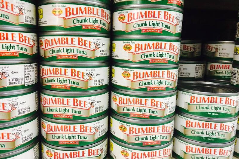 Cans of tuna are stacked in rows.