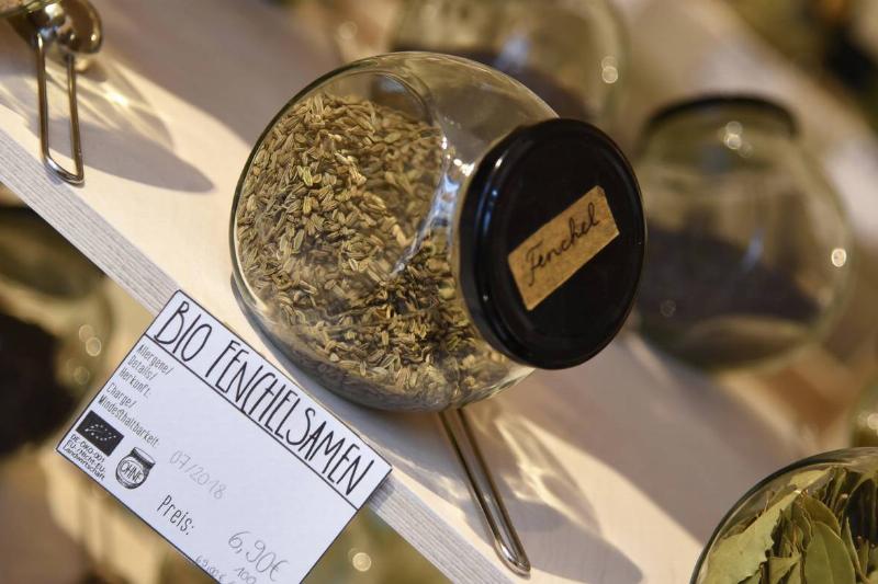 Dried fennel seeds are stored in a jar.