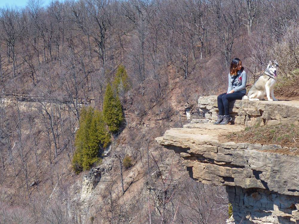 A woman poses with her dog at Dundas Peak.
