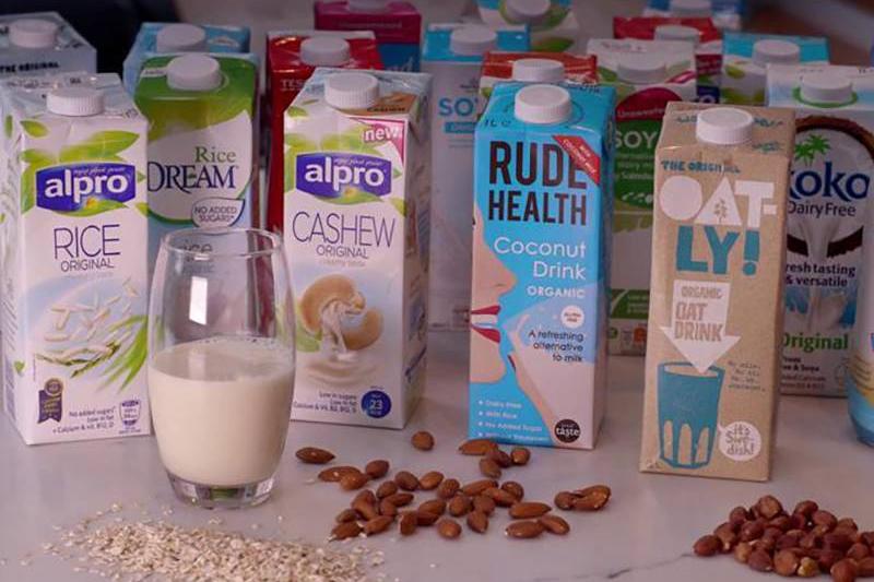 Several different cartons of milk alternatives are seen.