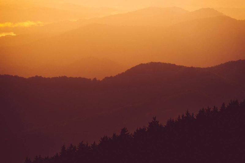 Hillsides are silhoutted at dusk.