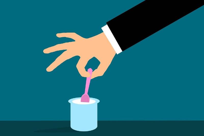 Clipart shows a man dipping a spoon into yogurt.
