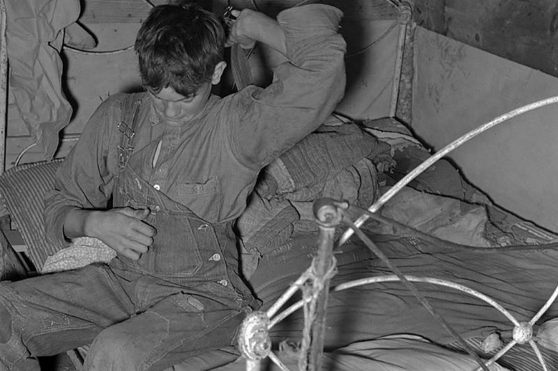 Boy putting on clothes 