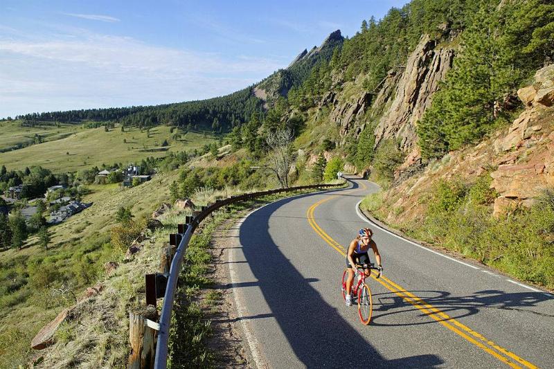 a cyclist on the side of a mountain in boulder, colorado