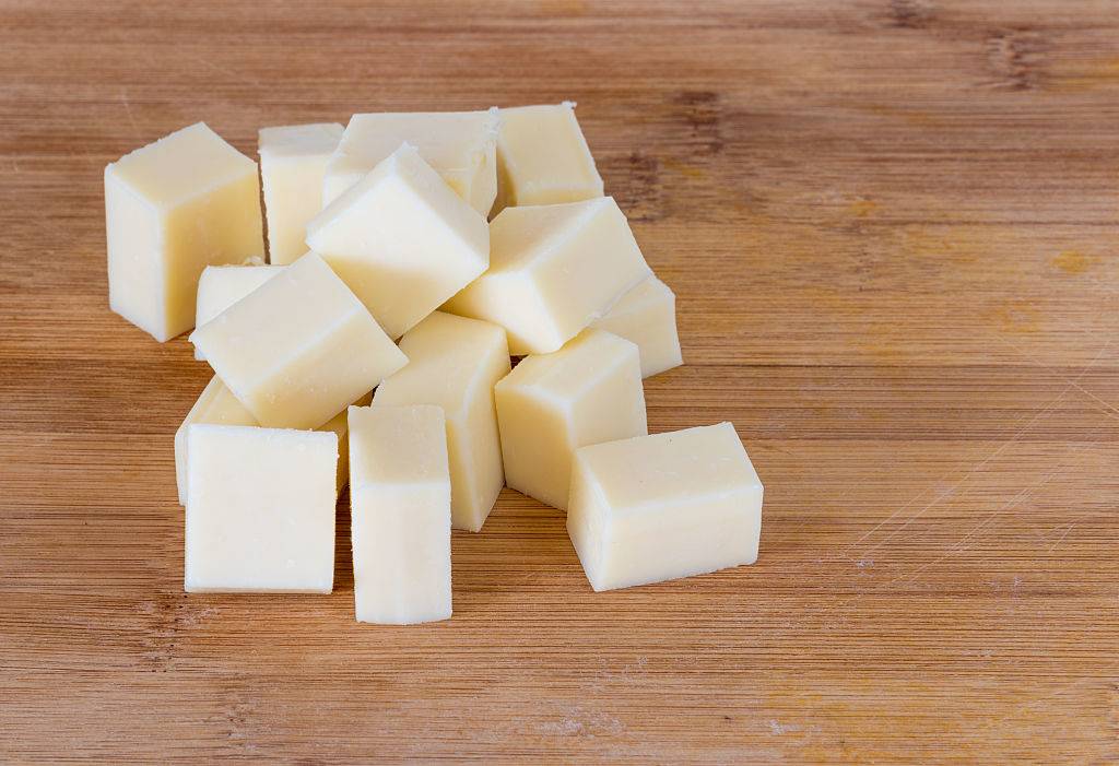 white cheese cubes on a wood table