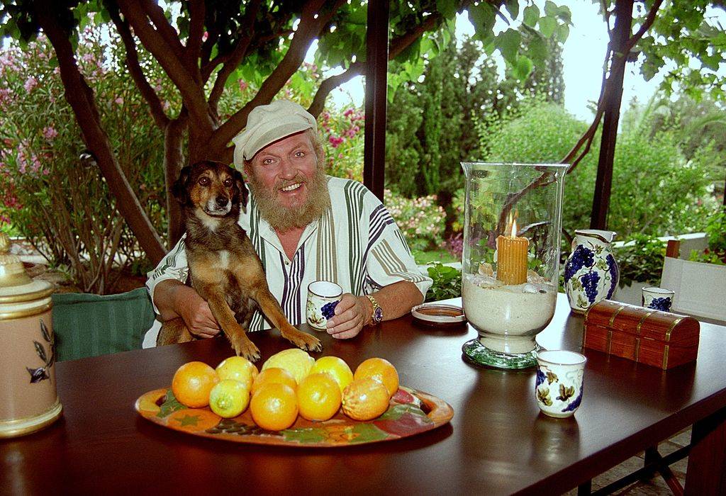 a man and his dog at a table full of lemons
