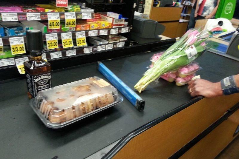 someone in line with flowers, someone with booze