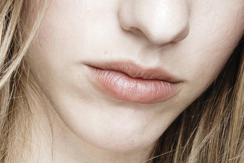 A close-up shows a model's lips.