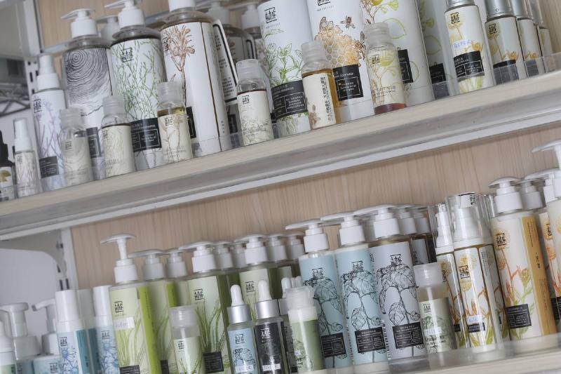 Organic skincare products line the shelves of a supermarket.
