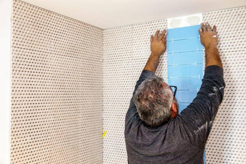 Miami Beach, contractor installing bathroom tile.