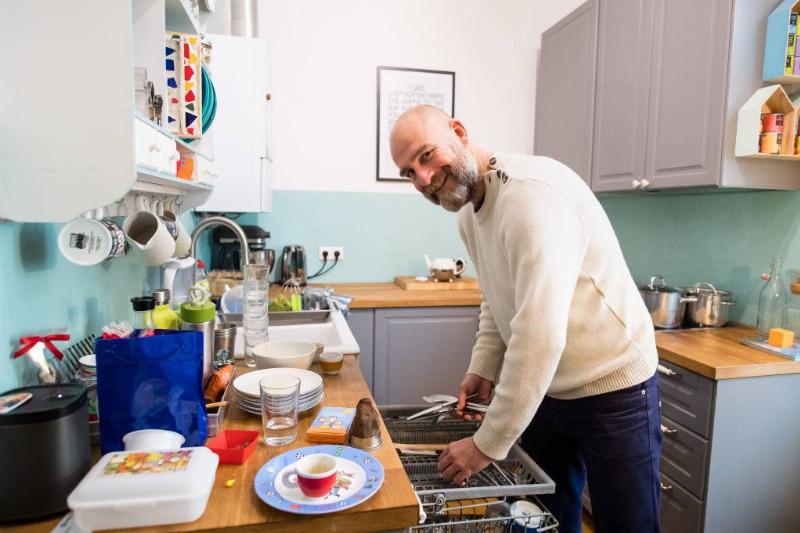 man washing dishes