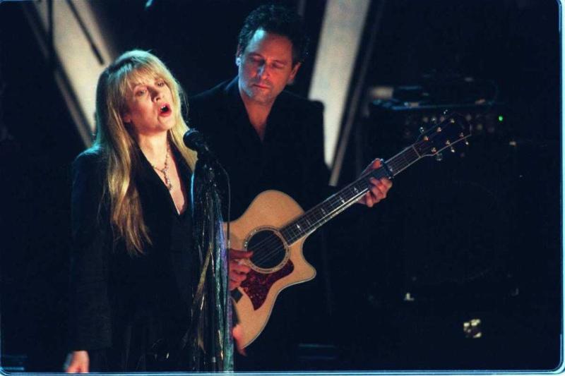 Stevie Nicks sings while bandmate Lindsey Buckingham looks on during a performance by Fleetwood Mac as the band is inducted into Rock & Roll's Hall of Fame