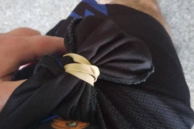 man tied rubberband around pocket from the inside