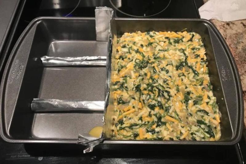 person used a few strips of aluminum foil to push all of recipe into one side of the pan
