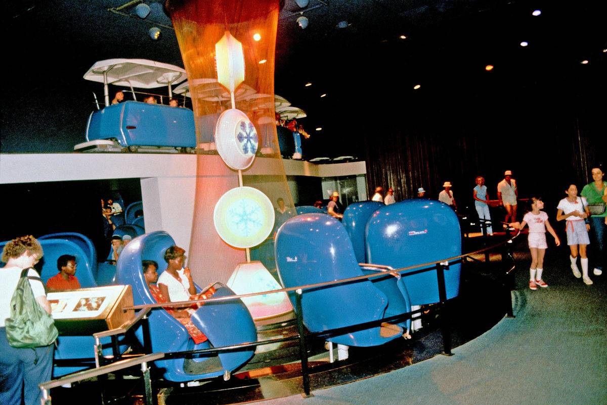 adventure through inner space ride with people sitting in blue pods at disneyland