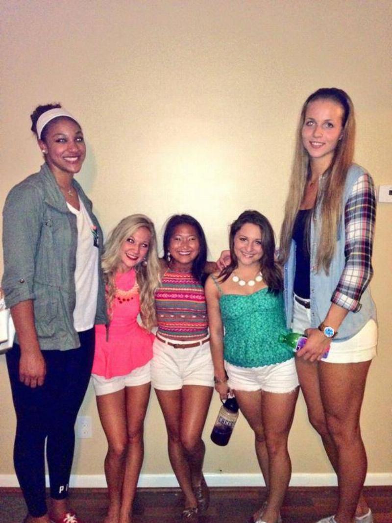 basketball players standing next to cheerleaders 