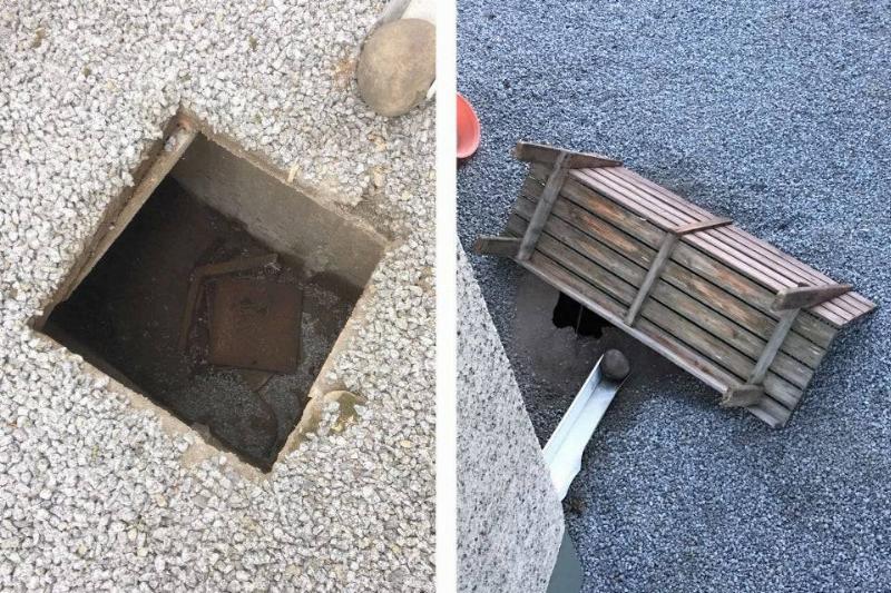 grate in backyard covered by bench