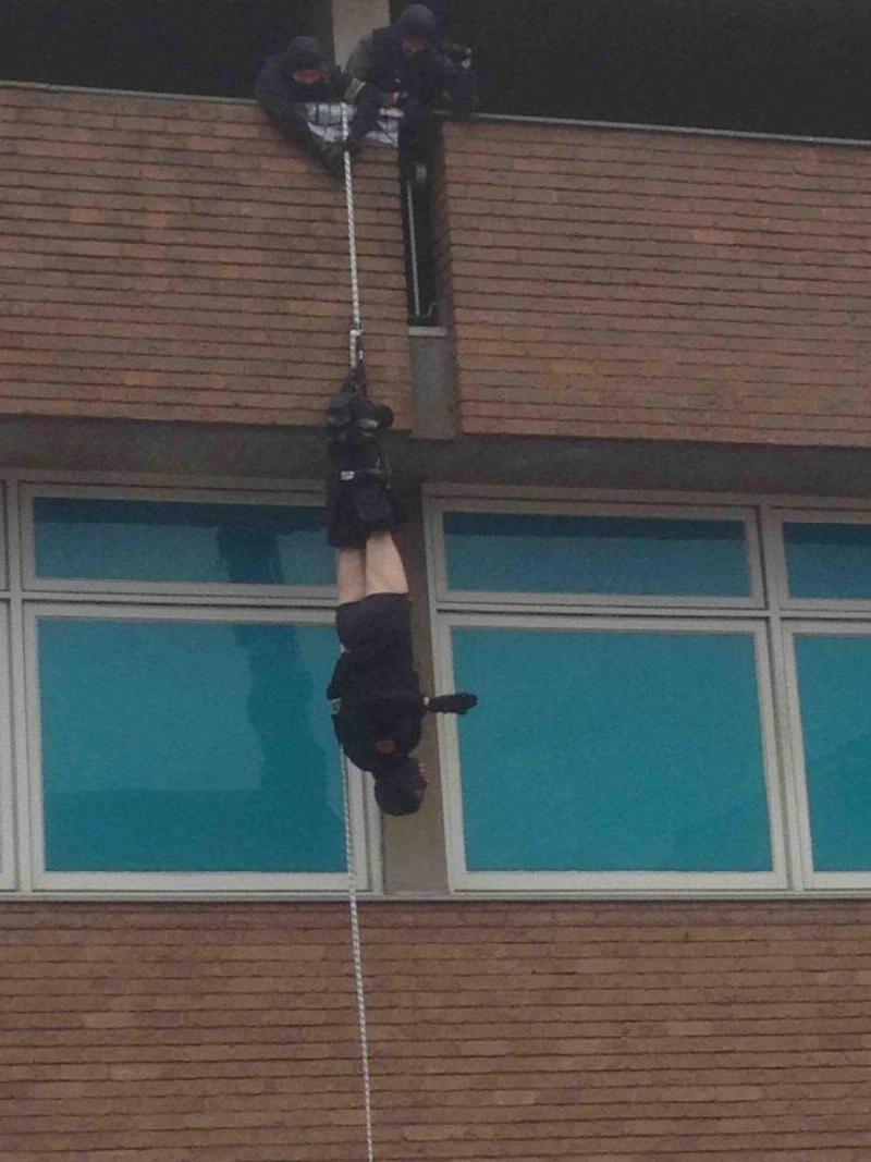 man hanging upside down pants fallen