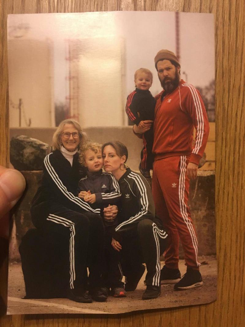 family all wearing adidas tracksuits