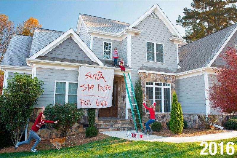 kids on roof with sign 