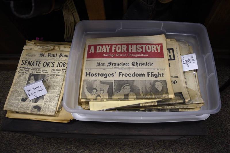 Historic newspapers for sale in an antique shop