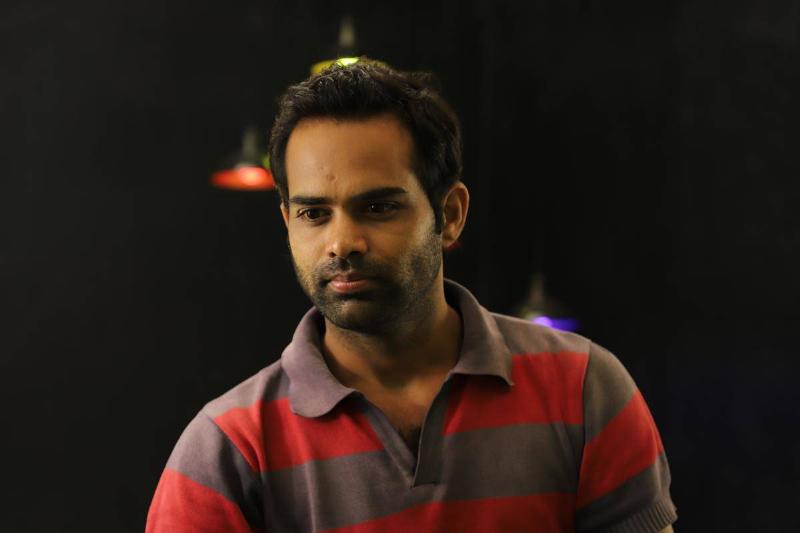 man in striped shirt with no emotion