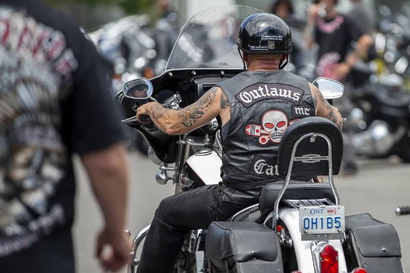  A member of the Outlaws motorcycle gang rides a bike.