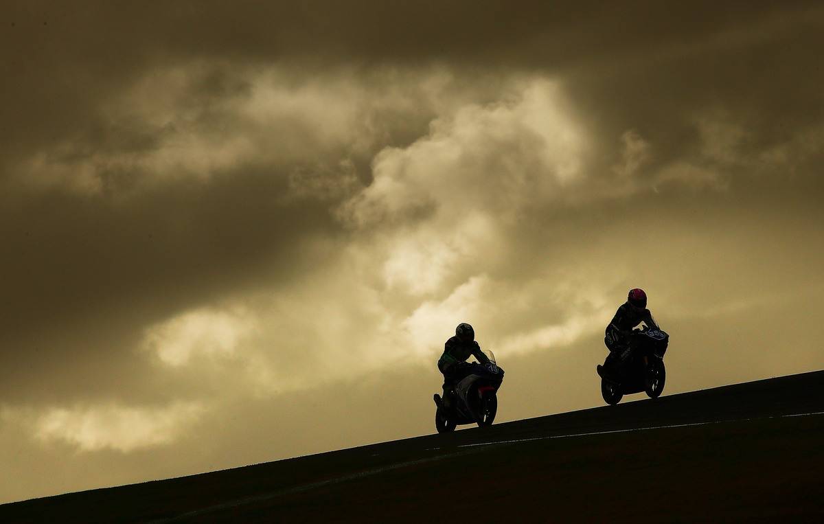 Motorcycle rides drive up a cliff in Australia.