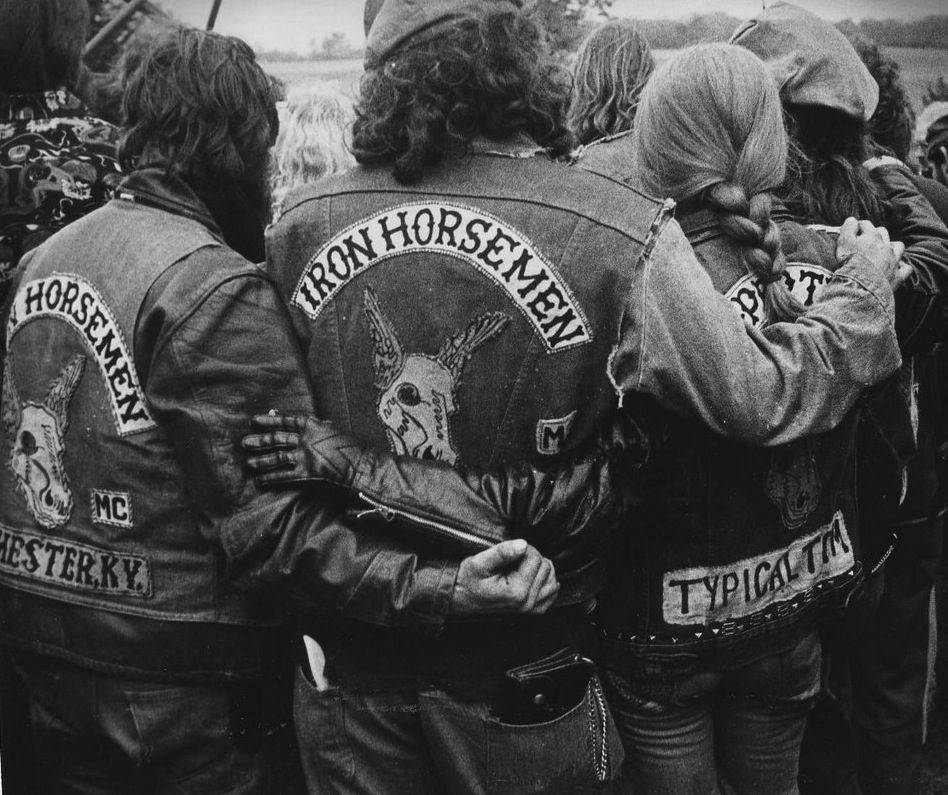 Members of the Iron Horsemen motorcycle club wrap their arms around each other.
