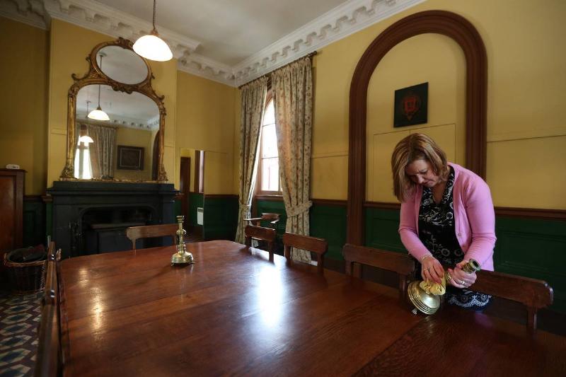 woman polishing on wooden table in staffordshire