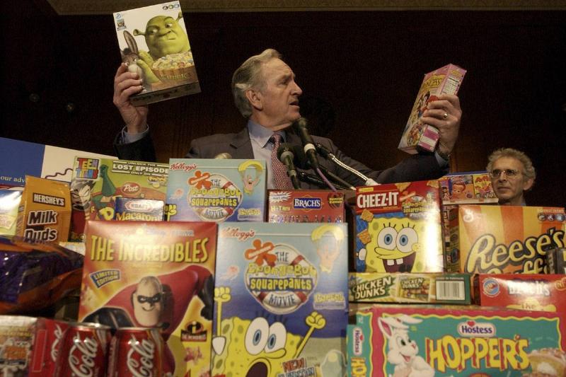 A man looks at sugary kid's cereals in disbelief.