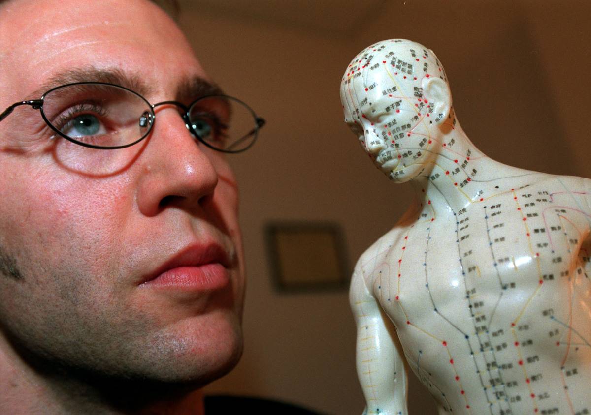 Talotta 1 - Troy MacLean in office pose with and is near plastic accupuncture model,nude with all ki