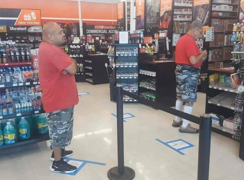 man wearing same outfit as guy in front of him in line