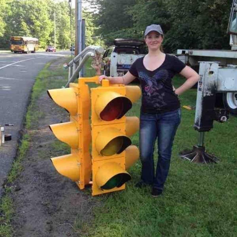 woman standing next to a traffic light