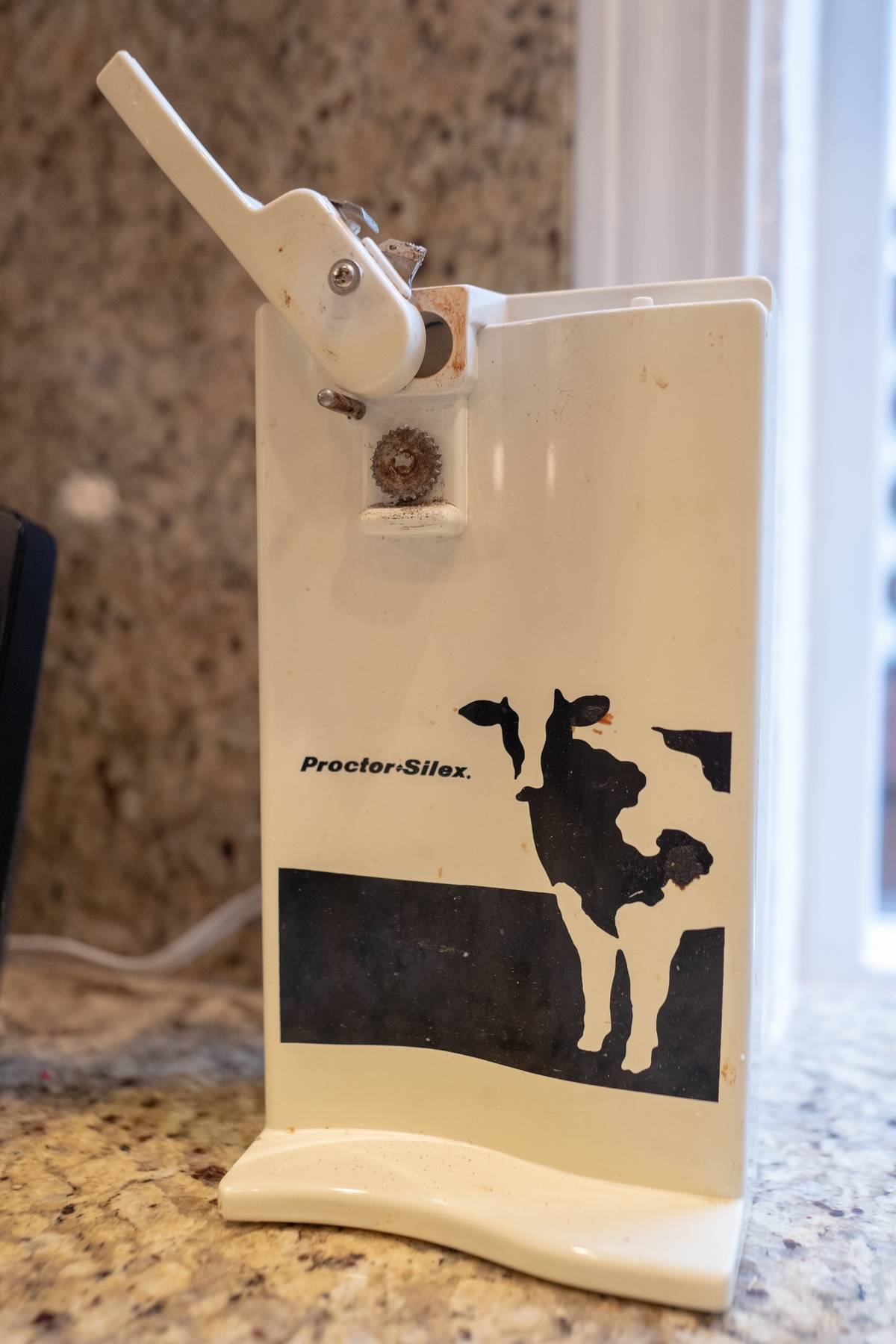 Vintage Can Opener with cow on it