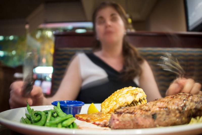 Closeup of a steak and lobster dish on a white plate in...