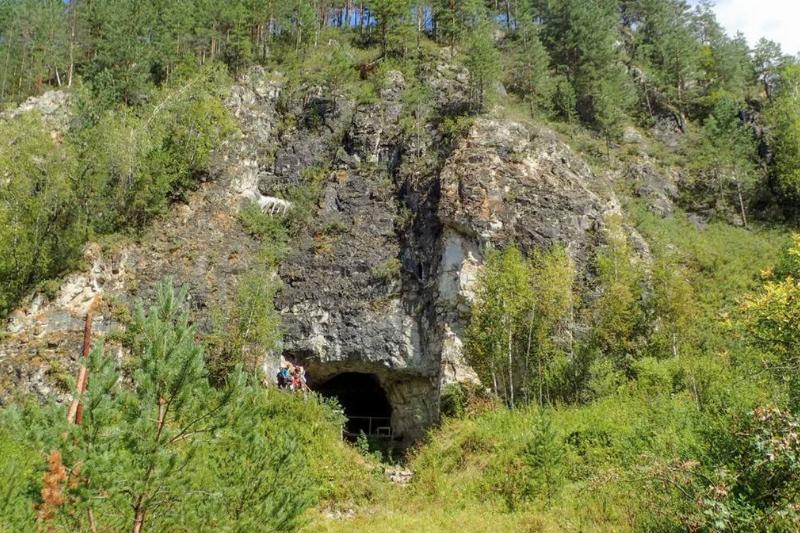 Hikers walk near the Denisova Cave in Siberia.