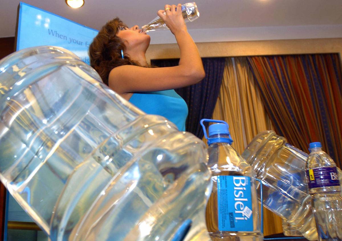 An Indian model drinks bottled drinking
