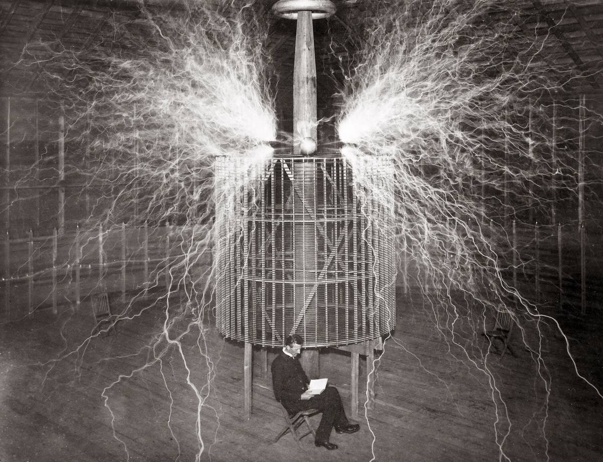 Nikola Tesla sitting in his Colorado Springs laboratory