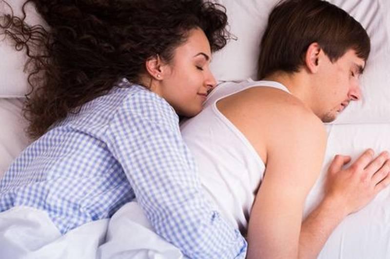 a couple spooning in bed