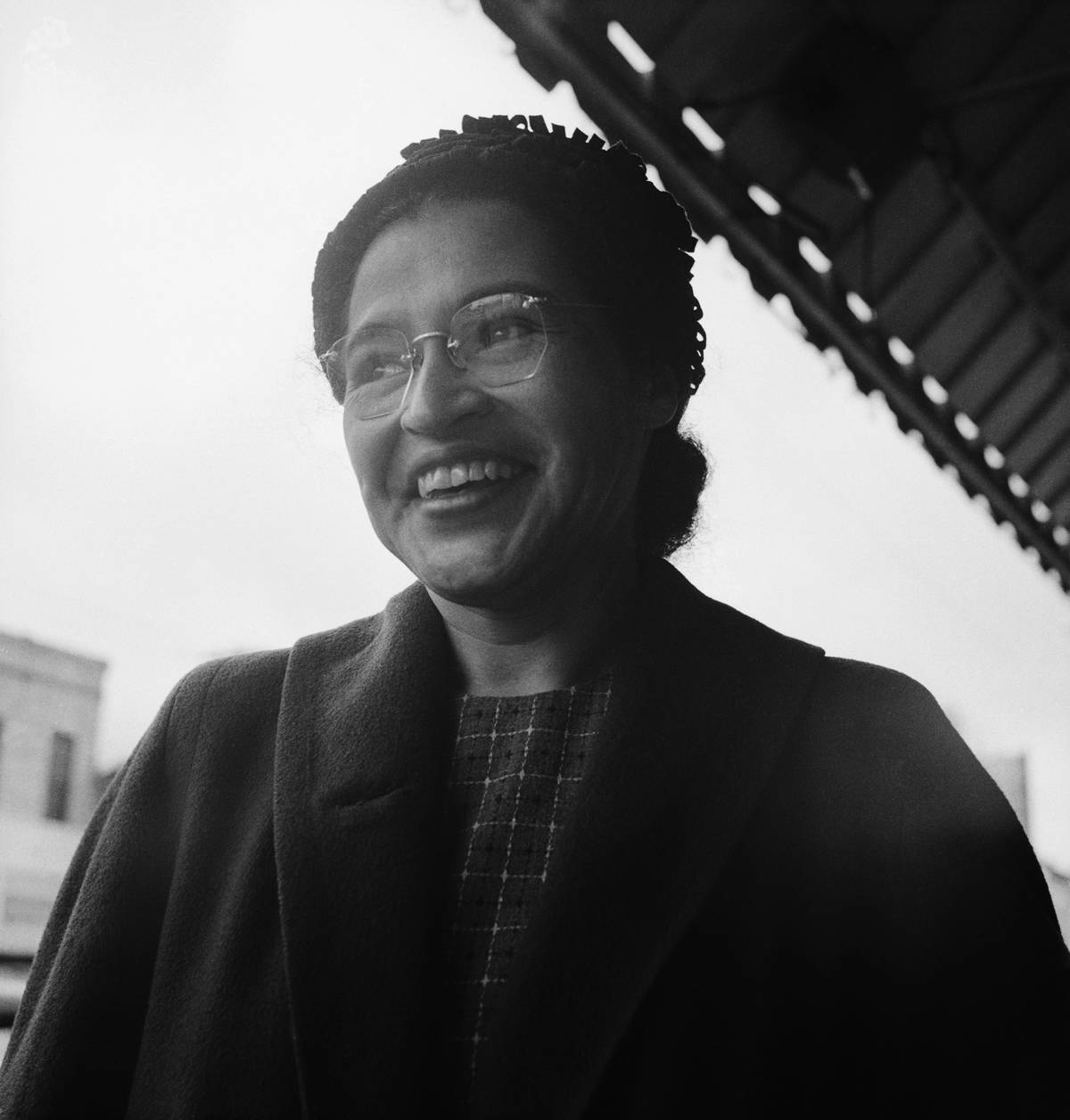 A female activist smiles after Supreme Court ruling banning segregation.